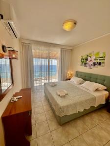 阿齐欧斯·贡多斯丽都索非亚公寓式酒店的一间卧室设有一张大床,享有海景