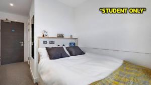 科尔切斯特Student Only Zeni Ensuite Rooms, Colchester的一间卧室配有带白色床单和枕头的床。