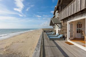 Wakefield6.5-Acre Oceanfront Estate的海滩上一排蓝色的躺椅
