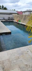 圣安德烈Villa Mary Guest House的庭院里的一个蓝色海水游泳池