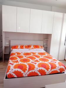 罗马casArancia的一间卧室配有一张带橙色和白色棉被的床