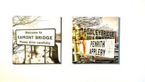 彭里斯Swallow Barn的两个表示欢迎装甲桥的标志和一条读路安全标志