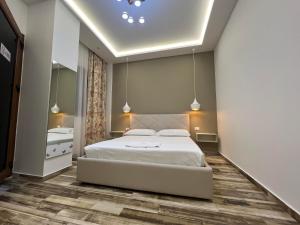 伏罗拉Guest Room Angolo Toscano的卧室配有一张白色大床和镜子