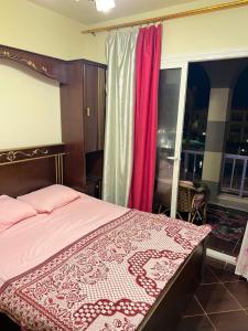 马特鲁港Porto Matrouh Chalet X Rent family only的一间卧室配有一张带红色和白色床罩的床。