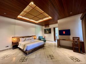 希德门阿扁阿玉别墅酒店的一间卧室配有一张床和一台电视