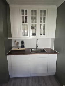 桑讷菲尤尔Cozy Central House的厨房配有白色橱柜和水槽