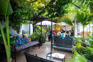 利文斯顿Victoria Falls Backpackers Zambia的餐厅内配有沙发和植物的庭院