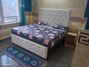 卡尔帕Wanderers Homestay -All mountain facing rooms的一间卧室配有一张带花卉床罩的床