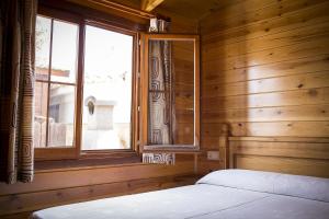阿兰约兹Aranjuez Camping & Bungalows的一间卧室设有一张床和一个窗口