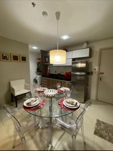 马塞约PAJUCARA FRONT BEACH 2的厨房配有玻璃桌和餐具