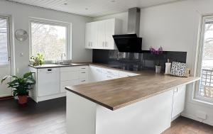 斯德哥尔摩The Luxurious Lakeview Villa near Stockholm的厨房配有白色橱柜和木制台面