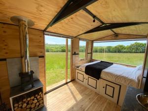 比迪福德Panoramic view pod in Woolsery的一间位于带大窗户的小房子的卧室