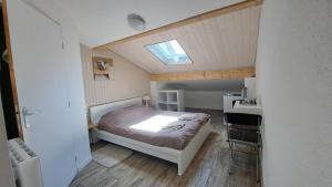 SongesonAux Lacs et Cascades的一间小卧室,配有一张床和一个天窗