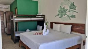 图卢姆Hotel Sonno Caliza Tulum的一间卧室配有一张床和双层床及棋盘