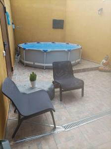 伊科德洛斯维诺斯Tradicional Casa Canaria con piscina y vistas al Teide的一间带两把椅子和浴缸的房间