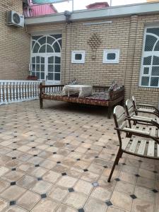 撒马尔罕帖木儿可汗酒店的一座带两把椅子和浴缸的庭院