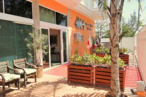 里约热内卢KS海滩酒店 的一座建筑前的庭院,庭院里摆放着椅子和一棵树
