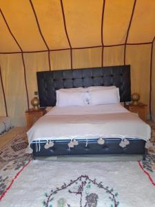 梅尔祖卡Luxury Desert Camp Merzouga的帐篷内一间卧室,配有一张床