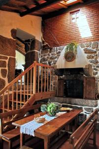 ValezimCasa do Forno的厨房配有木桌和石炉
