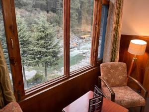 贾姆讷格尔Happy Valley INN的客房设有椅子和美景窗户。