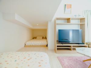熊本YOUR ROOM Kumamoto Sta little 203 Vacation STAY 75726的一间卧室配有一张床和一台平面电视