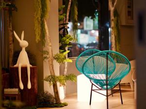 花莲市Finders Hotel Hualien Station的两把椅子,一个有植物和窗户的房间