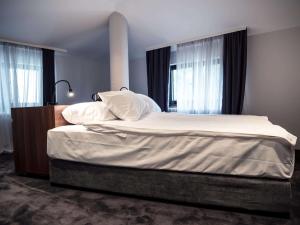 贝尔格莱德Best Western Premier Natalija Residence的卧室配有一张带白色床单和枕头的大床。