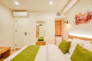 伊斯坦布尔Elephant In The Room Hotel的卧室配有带绿色枕头的白色床