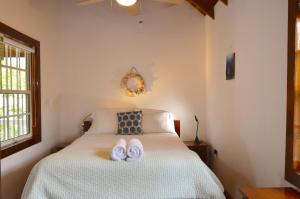库尔克岛Sea Garden Cottage的一间卧室配有一张床,上面有两条毛巾
