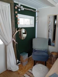 罗瓦涅米Experience accommadation Eco-Unela的一间设有蓝色椅子和镜子的客房