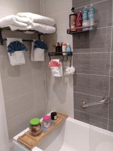 普雷斯科特House Rose 1的带淋浴和浴缸及架子的浴室