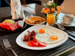 曼谷Ramada by Wyndham Bangkok Sukhumvit 11的包括鸡蛋培根和烤面包的早餐食品