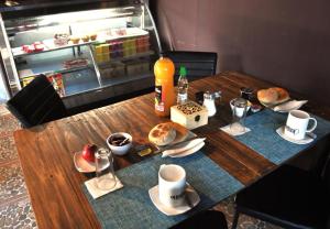 卡萨布兰卡Hostal Emporio的一张木桌,上面有食物和饮料