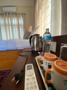 索拉哈Hotel Safari Suite的一张桌子,上面有遥控器和咖啡壶