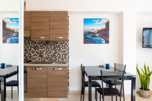 费拉约港Appartamento Il Mare e Dintorni的厨房以及带桌椅的用餐室。