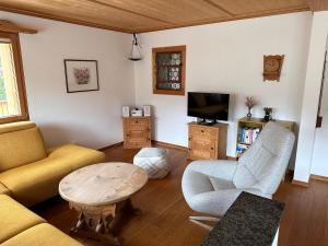 克洛斯特斯Ferienwohnung Crameri的带沙发、桌子和电视的客厅