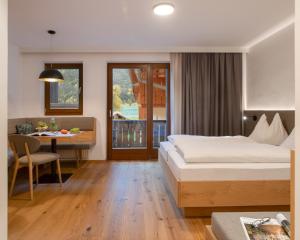 魏森湖菲伦霍夫纽泽哈尔莫泽酒店的酒店客房设有一张床铺、一张桌子和一间用餐室。