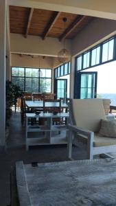 SengaJoma Adventure Lodge的客厅配有桌椅和窗户。
