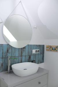 DębogóryDworek Wiatrów的浴室设有白色水槽和镜子