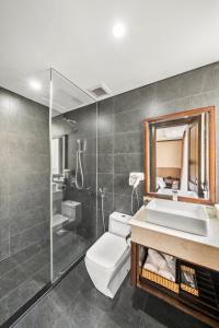 岘港Palazzo 3 Danang Hotel的一间带卫生间、水槽和镜子的浴室