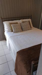 SavanetaQuiet and cozy cunuco guesthouse in Savaneta的一张带白色床单和枕头的床