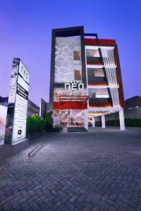 泗水Hotel Neo Gubeng by ASTON的前面有标志的建筑