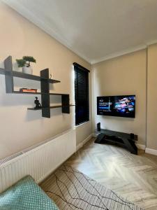 伦敦Park House, Luxury Modern Interior, Located In Finsbury Park的客厅的墙上配有平面电视。