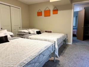 芝加哥Couture Themed 3 Bedroom in Prime Spot with Patio, Parking, Fireplace, Pets Welcome的墙上有橙色图片的房间的两张床