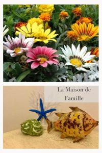 奥尔比亚La Maison de Famille的两幅花画和一幅鱼画的拼贴画