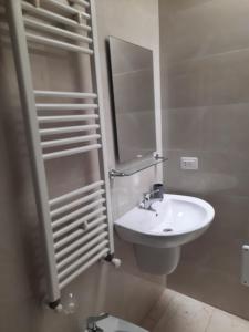 切萨雷奥港La Vela Apartaments - Porto Cesareo的白色的浴室设有水槽和镜子