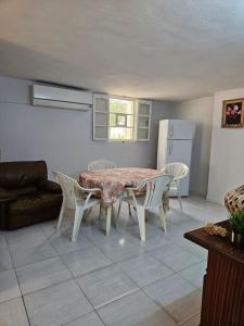 托泽尔Hadhri Appartement的客厅配有桌椅和冰箱。
