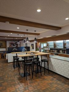 蒂蒂湖-新城Brauereigasthof Bären的一间带桌子和酒吧凳的餐厅
