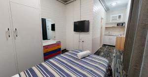 阿德莱德West End Motel的一间带床和电视的小卧室