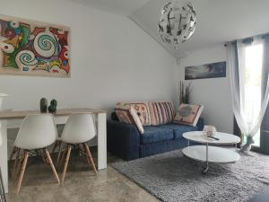 鲁伊德拉El Respiro的客厅配有蓝色的沙发和两把白色的椅子